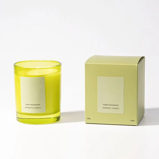 Yellow-green glass candle jar beside a matching-color box