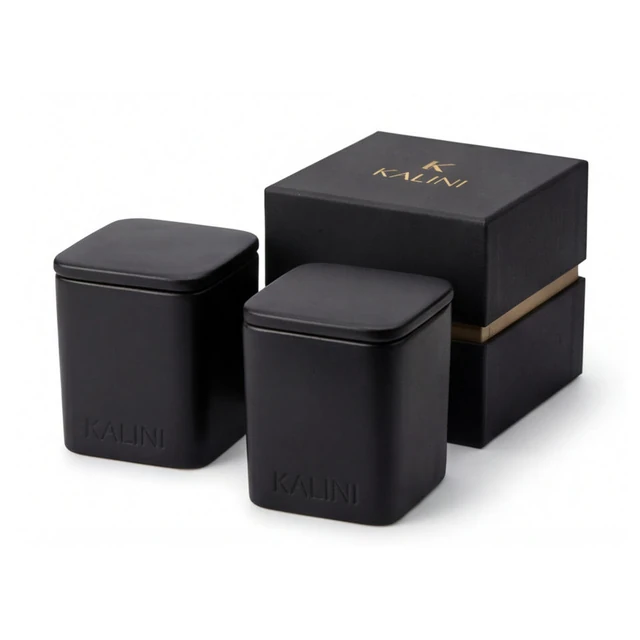 Black square ceramic candle jars with lids and a black box
