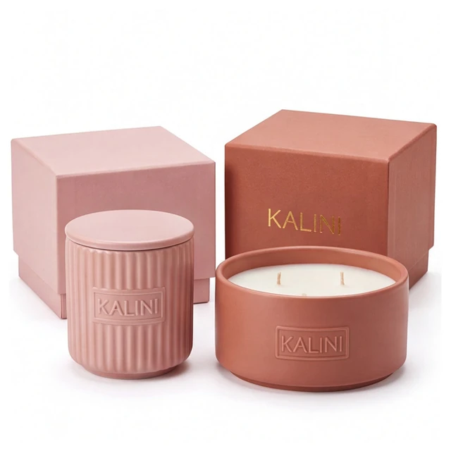 Pink fluted ceramic candle jar and terracotta-color bowl with separate color-coordinated boxes