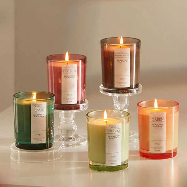 Colored round glass candle jars arranged on different display levels