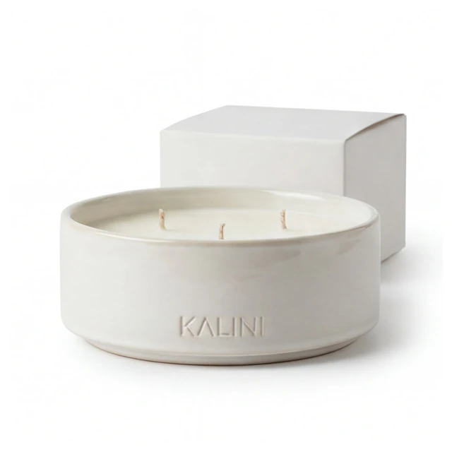 Low ivory ceramic candle bowl beside an ivory presentation box