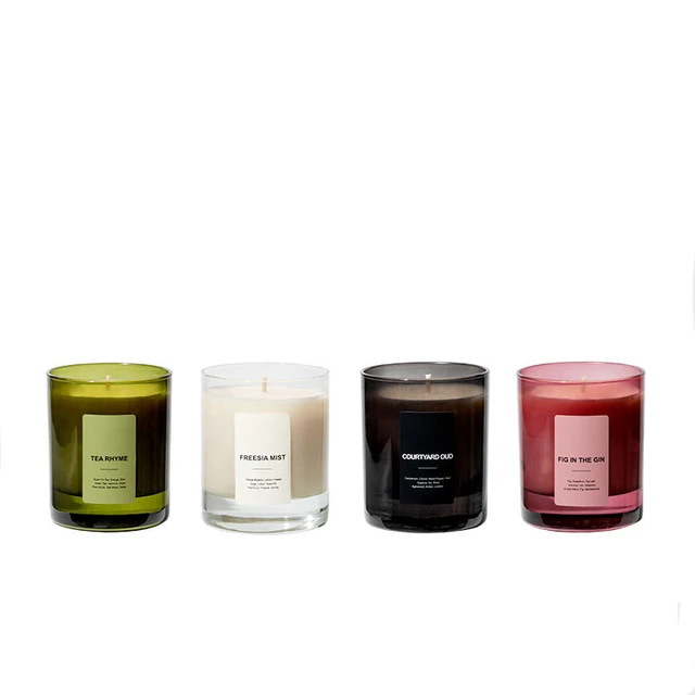 Green, clear, dark and pink glass candle jar bodies in a row